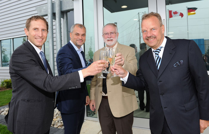 Carsten Kulcke, Darryl King, Doug Craig and Dieter Morszeck, CEO of Rimowa, toast after the ribbon cutting.